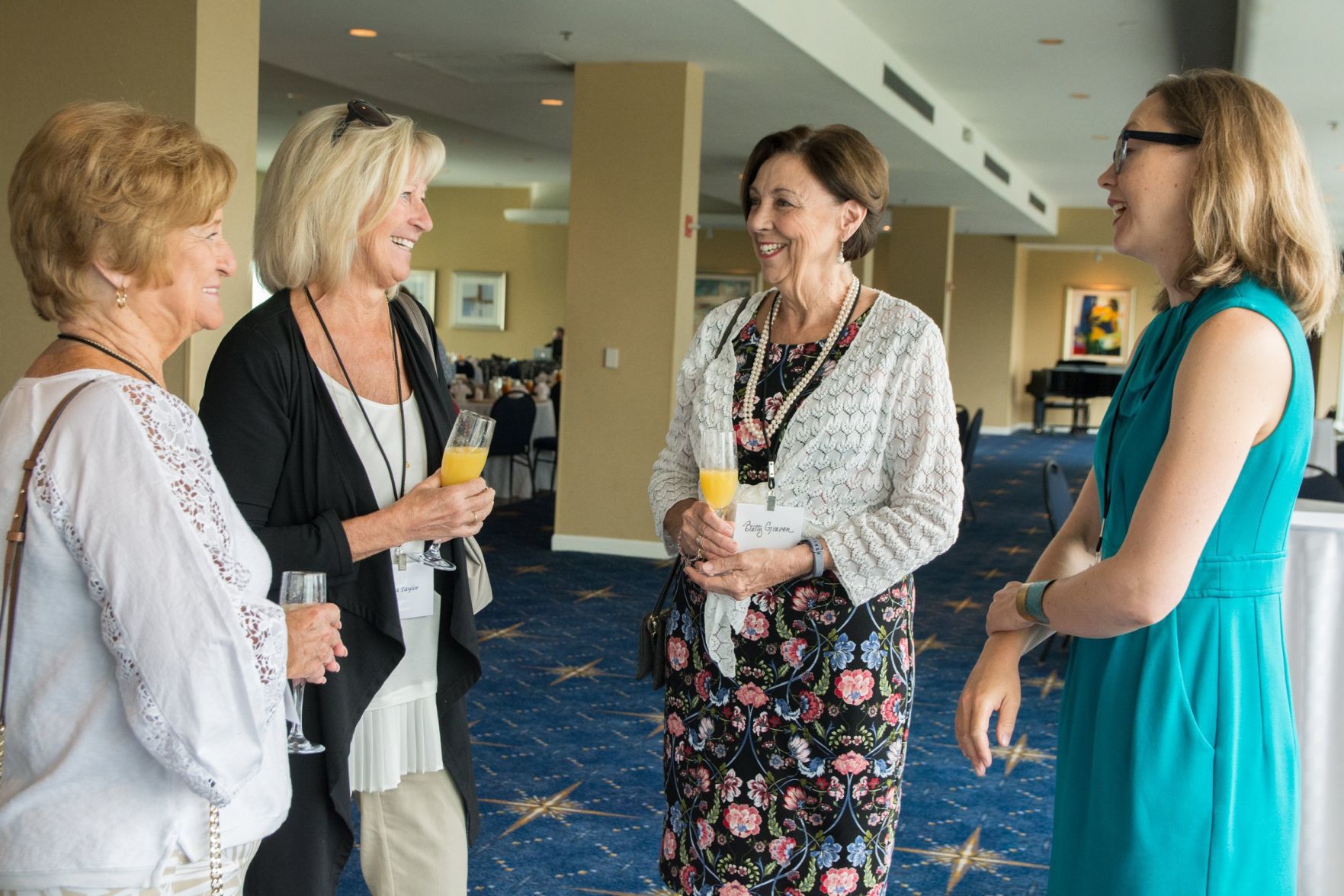 Attendees of the event chat before the luncheon.